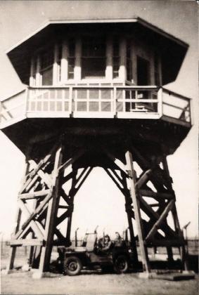 GUARD TOWER—This is a view of one of the 12 guard towers at the Prisoner of War camp just outside of Hereford in Castro County that housed Italian POWs. The jeep beneath the building provides scale.