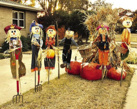 BUSHELS OF BLESSINGS-- Thanksgiving-styled yard decorations bring a harvest theme to a local neighborhood, bringing to mind just some of the things we have to be thankful for in this season of remembering and feasting. The frost has not been on the pumpkin all that much this fall, but a few snappy mornings and crisp afternoons have brought to mind past times of gathering fodder in the shock. (Photos by Jim Steiert)
