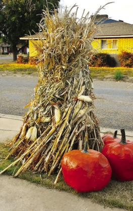 BUSHELS OF BLESSINGS-- Thanksgiving-styled yard decorations bring a harvest theme to a local neighborhood, bringing to mind just some of the things we have to be thankful for in this season of remembering and feasting. The frost has not been on the pumpkin all that much this fall, but a few snappy mornings and crisp afternoons have brought to mind past times of gathering fodder in the shock. (Photos by Jim Steiert)