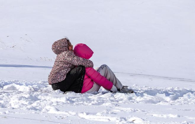 Enjoying the snow by sledding
