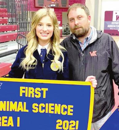 (Photo right) Kari Schulte holds her banner at the FFA Area 1 Convention held at WTAMU.