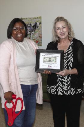 Tulia Chamber of Commerce Executive Director Ja’Nell Wafer presented Carla Edwards of Swisher County Title Company with the traditional First Dollar at their recent ribbon cutting.