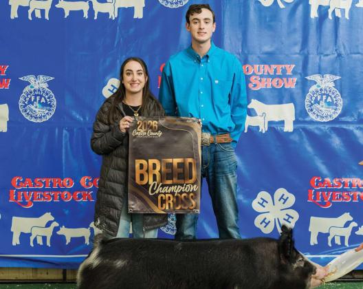 Zac Huseman is pictured with his Breed Champion Cross.