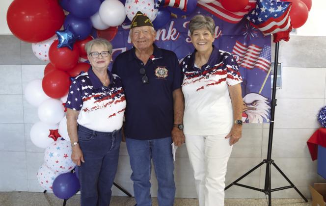 VFW Auxiliary Lee Ann Holt, VFW Darrell Scott, VFW Auxiliary Ka Wilfong were greeters at the Veterans Day Program