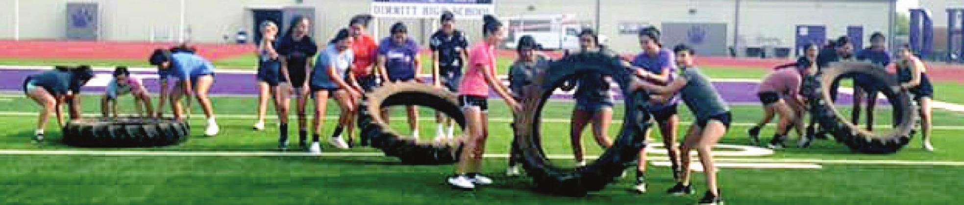 Heavy tractor tires make for an interesting workout tool for the Dimmitt Bobbies.