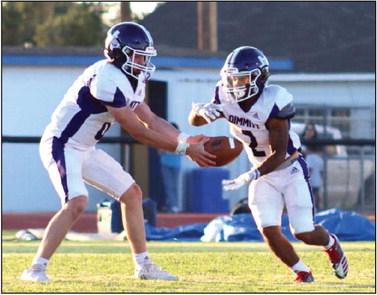 The Bobcats quarterback hands the ball off as Olton defense presses down. (Dimmitt Sports Media)