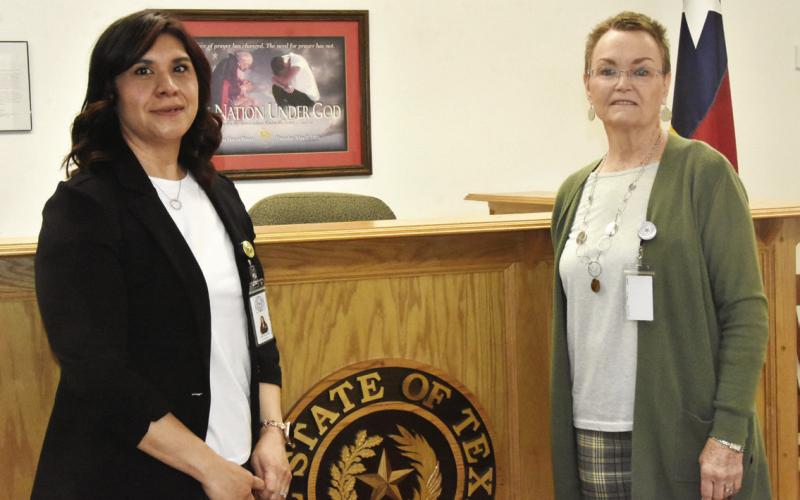 PASSING OF THE GAVEL-It was a changing of the guard at the March 24 as county commissioners voted unanimously to designate Alma Mancinas, left, as acting Justice of the Peace effective April 1 with the retirement of Karen Boren, right, as Justice of the Peace effective March 31. Mrs. Mancinas has worked with Mrs. Boren for 10 years and was unopposed in the March 3 Primary election.