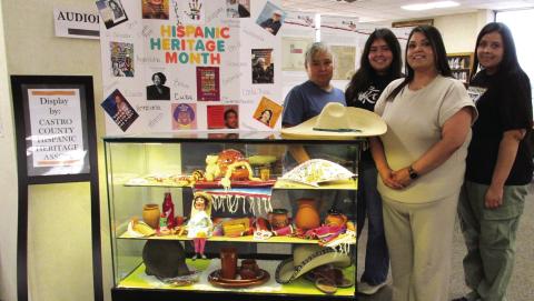 Display for the months of September and October, 2026, at Rhoads Memorial Library features items pertaining to Hispanic Heritage Month. Exhibiting some of their cultural items are, from left, Ofelia Lopez, Maria Lopez, Priscilla Peralta, and Laura Carrasco.