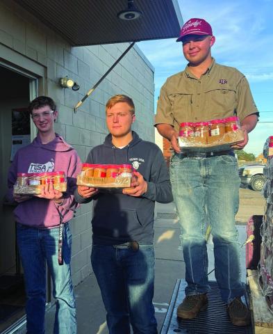 Deaf Smith County 4-H members (from left) Sam Detten, Josef Grotegut and Johan Grotegut chipped in last week to help deliver staples to the Hereford Food Pantry. (Courtesy photo)