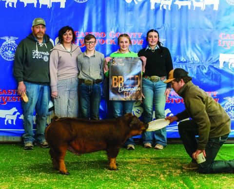Addie Birkenfeld is pictured with her Breed Champion Duroc.