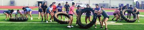 Heavy tractor tires make for an interesting workout tool for the Dimmitt Bobbies.