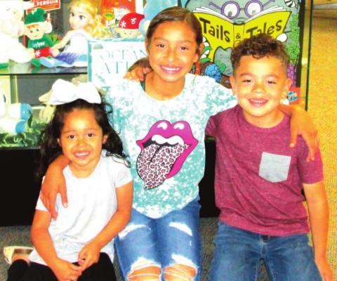 June and July displayers are Karen, Kaylynn and Kyle Grado who are exhibiting some of their stuffed animals to carry out the theme of "Tails and Tales" for Rhoads Memorial Library's summer reading program.