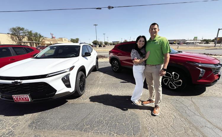 Isaac and Rita Walker of Stevens 5-Star Car &amp; Truck Center stand in front of two new 2026 Chevrolet Trax, the same model of car which will be given away to one Hereford High School senior Friday night during Hereford High School graduation.