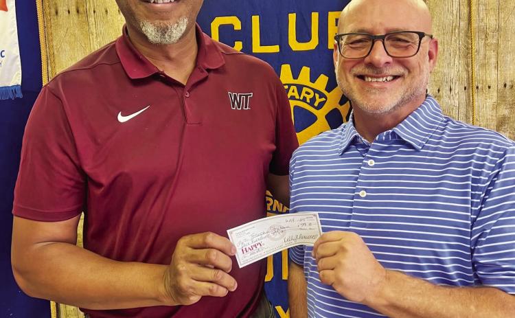 Joseph’s Storehouse representative Tyson Willis accepted a donation from Robert Bazemore of Tulia Rotary Club.