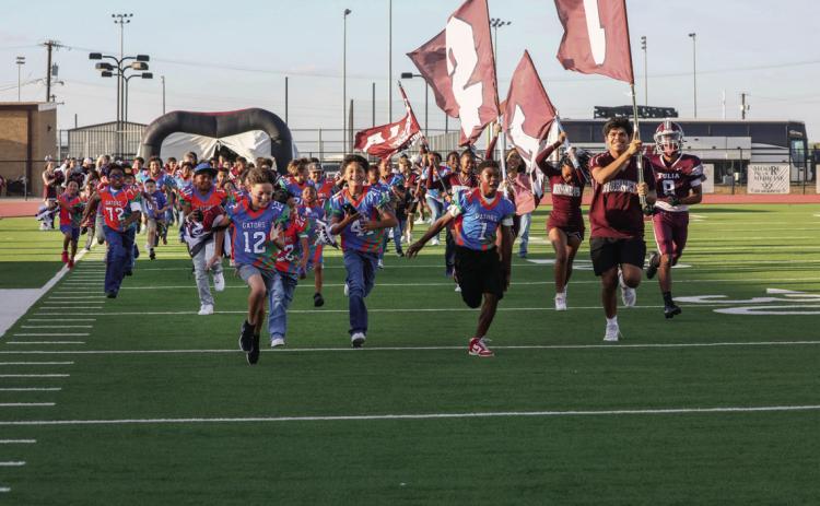 Future Hornets from the Tulia Junior High and Tulia Gators led the team onto the field for the Homecoming game.