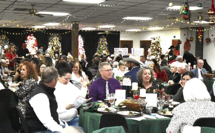 GLITZY SURROUNDINGS—Gala goers are surrounded by glitz at the Festival of Trees. (Photo by Jim Steiert)