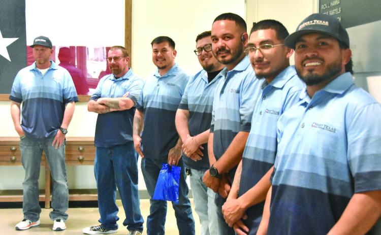 WAITING IN THE WINGS--Members of the outside crew from West Texas Rural Telephone Cooperative await duties of delivering door prizes to lucky winners at the 71st annual membership meeting March 24. (Photo by Jim Steiert)