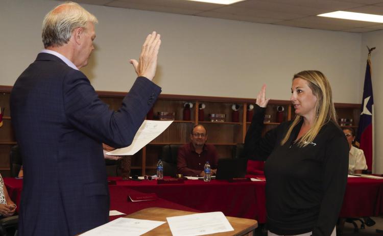 Swisher County Judge Michael Clawson administers the oath of office to Tulia ISD School Board Trustee Kacy Quinton
