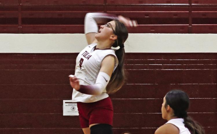 Marleigh Russell jumps high to hit the ball