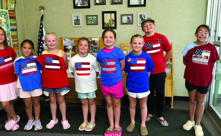 To get ready for the nation's 250th birthday, Castro Coun - ty 4-H made American Flag T-shirts and coasters June 14. The group learned about using fusible to make our flag, sewing on a T-shirt and using a sewing machine to not stitch both sides, strip piecing to make a coaster and us - ing fusible to add stars. (Courtesy photos)