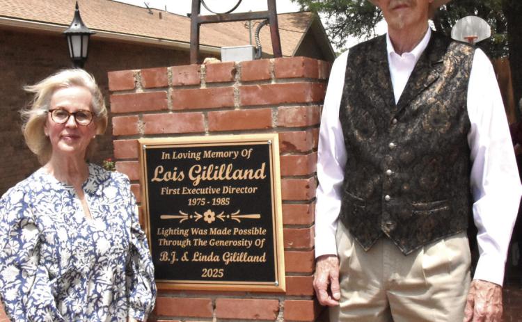 THANKS FOR SUPPORT--Linda and B.J. Gililland stand next to the plaque on the west side of the Ruby K. Sears Memorial Garden during a ceremony hosted by the Deaf Smith Historical Society honoring their support for the Deaf Smith County Museum. They were recognized for funding new electrical wiring and lighting at the Sears Garden. They are long-time supporters of the Deaf Smithsonian. .(Photo by Jim Steiert)